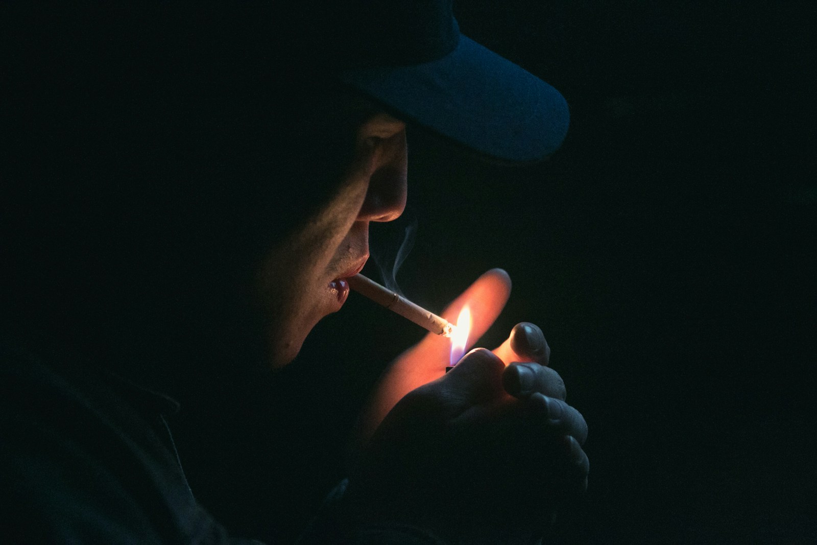 man lighting his cigarette